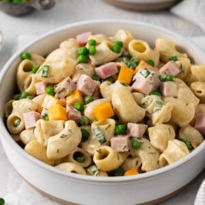 Ham and pea pasta salad in a bowl.