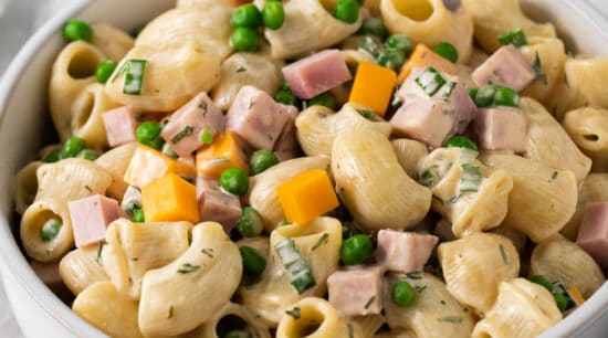 Ham and pea pasta salad in a bowl.