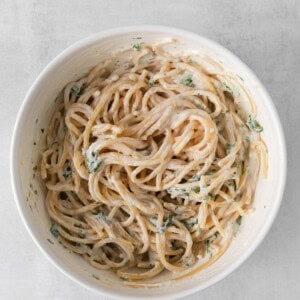 a bowl of pasta with a sauce on it.