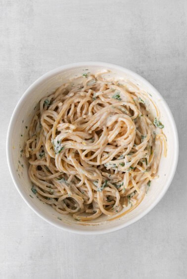 a bowl of pasta with a sauce on it.