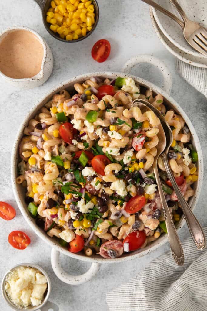 Mexican pasta salad in a bowl with 2 spoons.