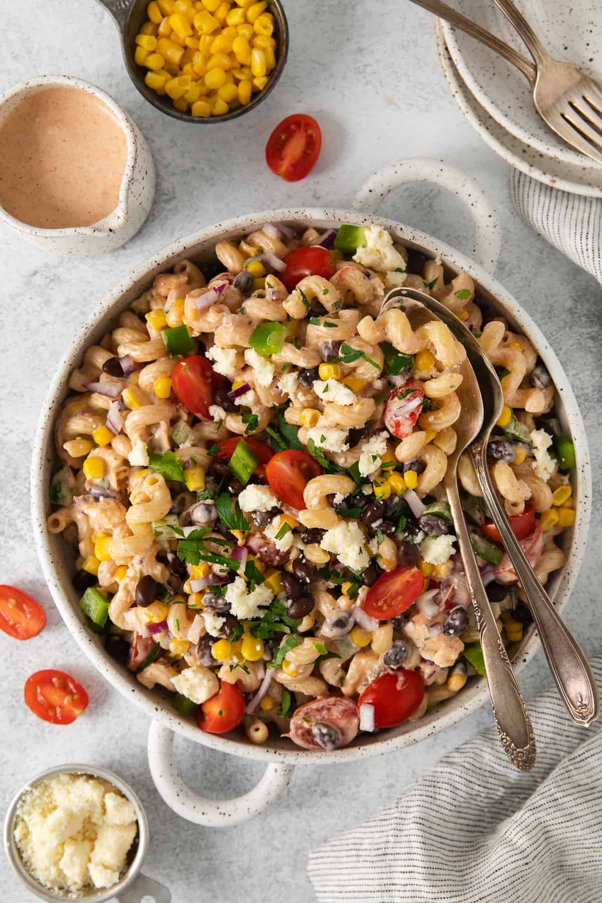 Mexican pasta salad in a bowl with 2 spoons.