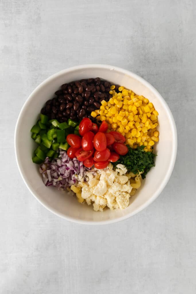 Mexican pasta salad ingredients in a bowl.