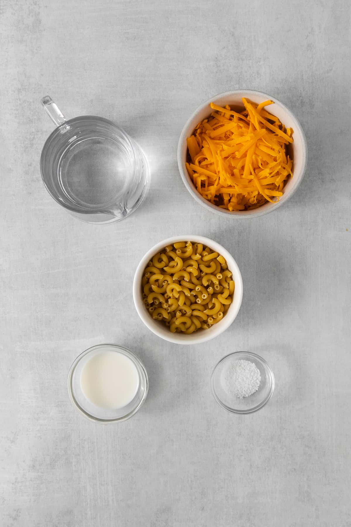 Ingredients for microwave mac and cheese in bowls.