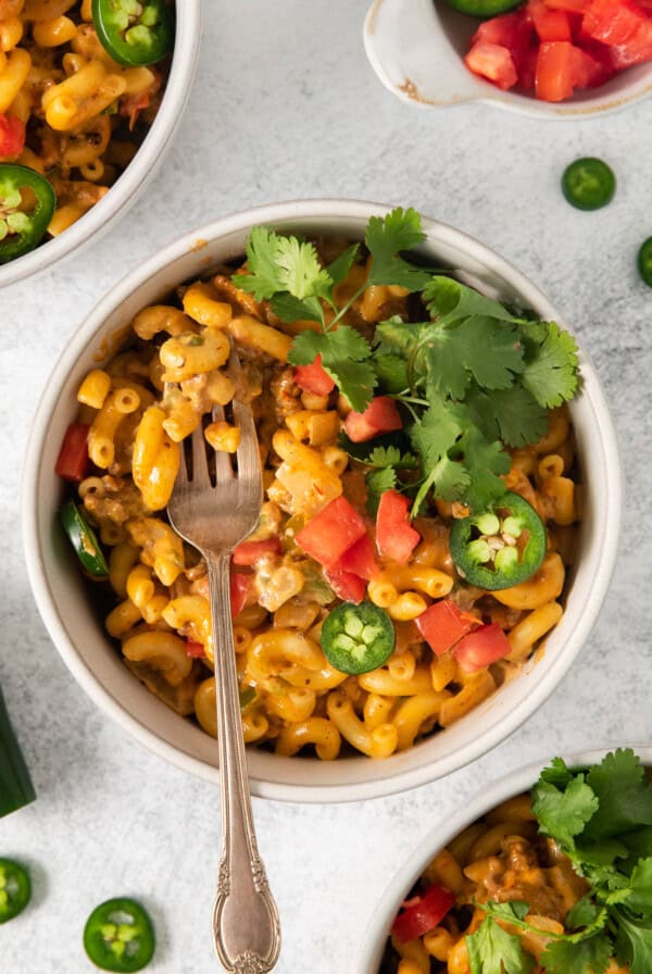 Taco mac and cheese in a bowl with a fork.