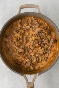 a skillet filled with meat and vegetables.