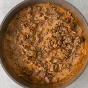 a skillet filled with meat and vegetables.
