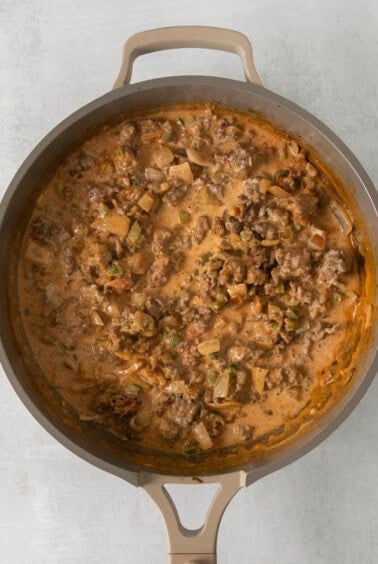 a skillet filled with meat and vegetables.