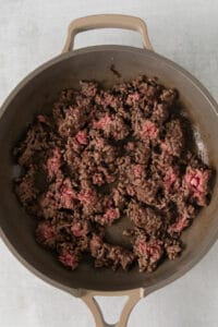 ground beef in a skillet on a white surface.
