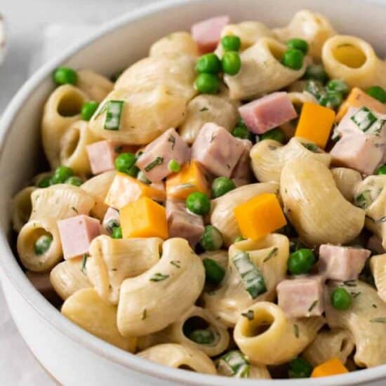 Ham and pea pasta salad in a bowl.