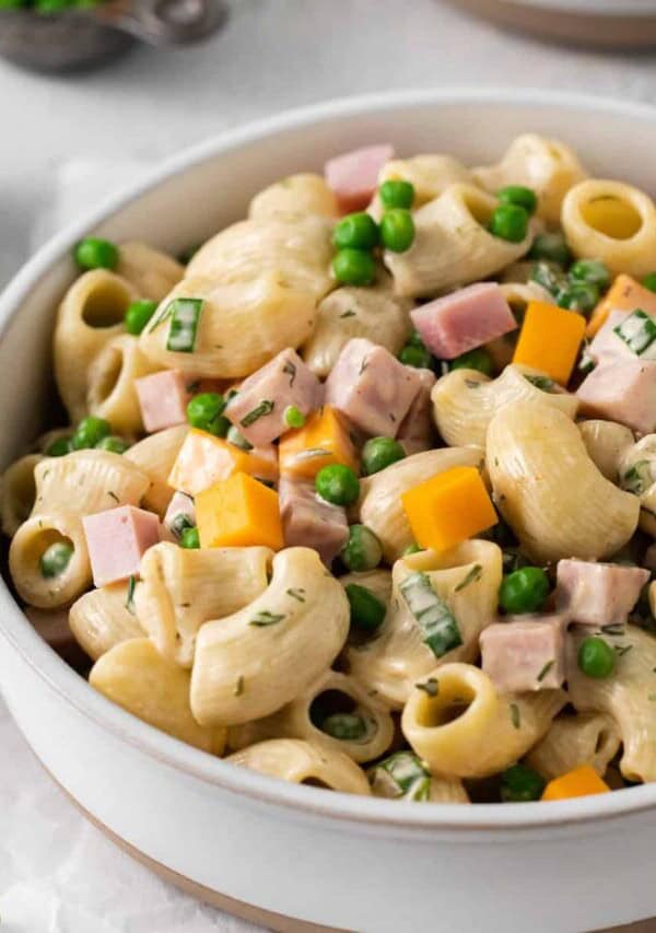 Ham and pea pasta salad in a bowl.