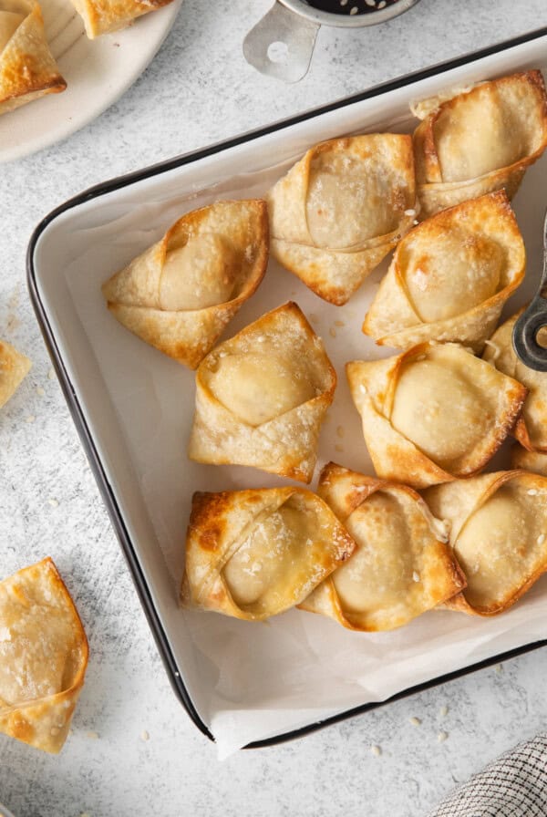 fried dumplings in a baking dish with a fork.