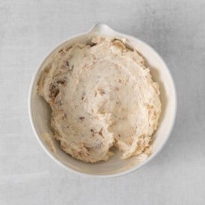 a white bowl filled with mashed potatoes.