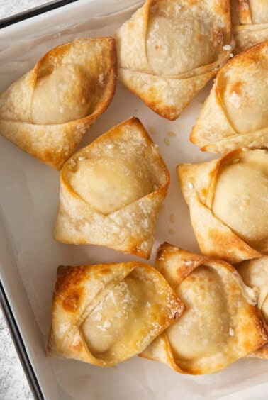 a baking dish with a tray of fried dumplings.