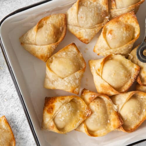 a baking dish with a tray of fried dumplings.