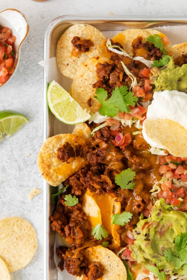 Ground beef nachos topped with all the fixings.