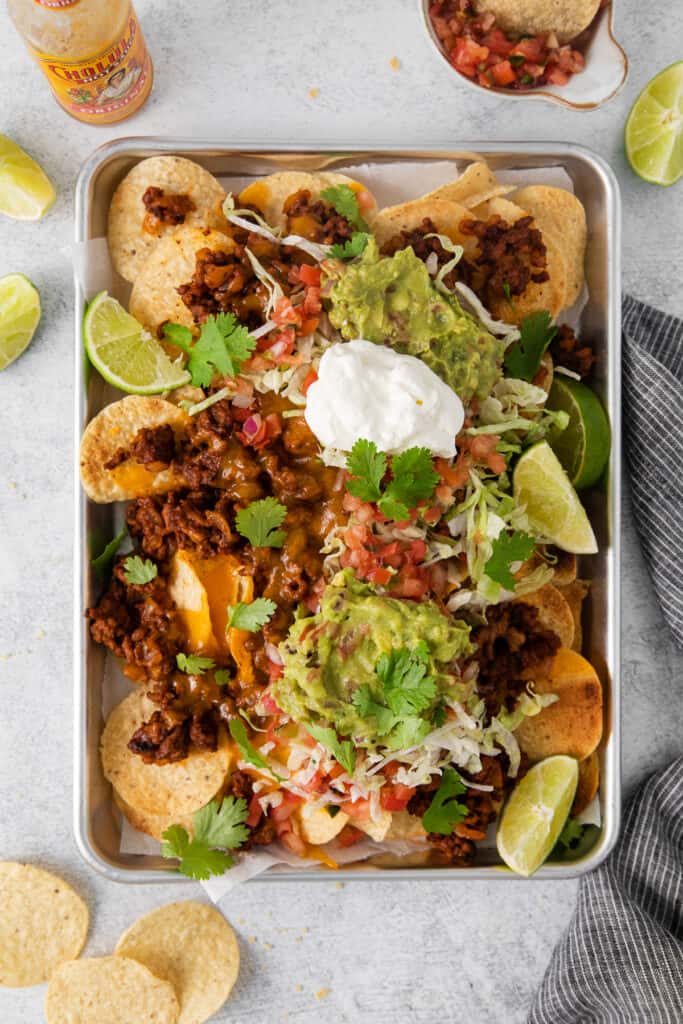 Ground beef nachos topped with all the fixings.