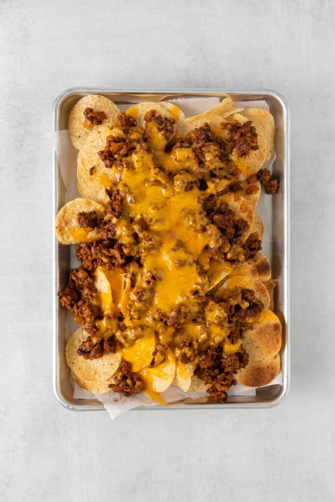 Nachos topped with ground beef and melted cheese.