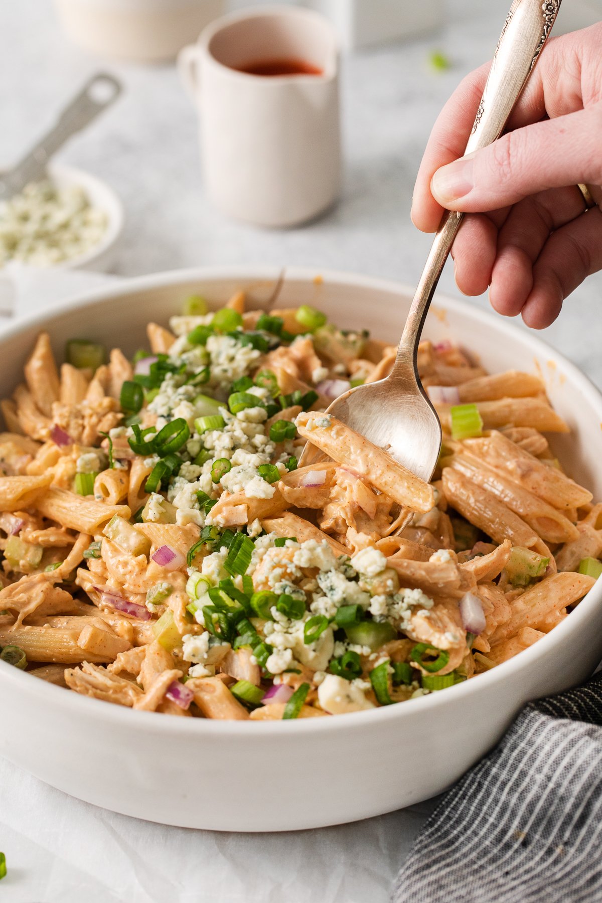 Buffalo chicken pasta salad on a spoon.