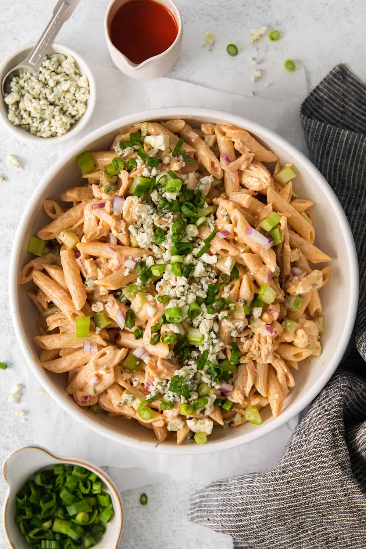 Buffalo chicken salad in a bowl topped with blue cheese.