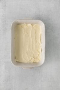 whipped cream in a square dish on a gray background.