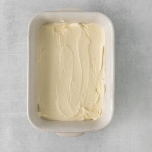 whipped cream in a square dish on a gray background.