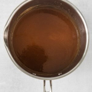 a pan full of brown liquid on a white surface.