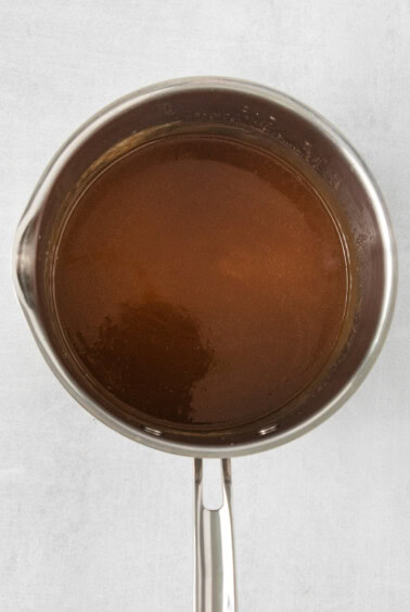 a pan full of brown liquid on a white surface.