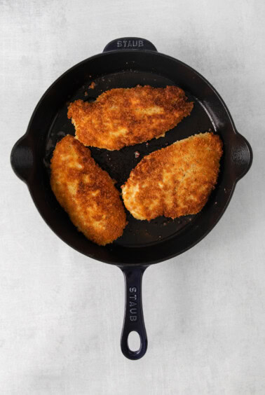 fried chicken in a cast iron skillet.