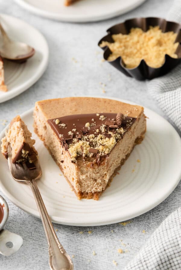 Slice of churro cheesecake on a plate.