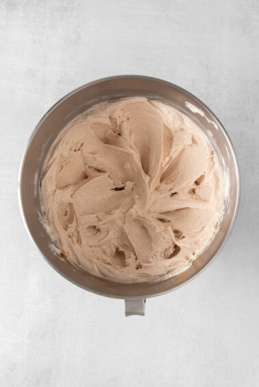 vanilla ice cream in a bowl on a white surface.