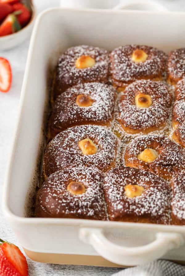 Hawaiian roll french toast in a casserole dish.