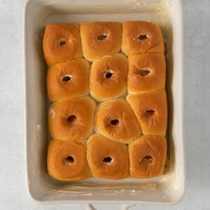 bagels in a baking dish on a white surface.