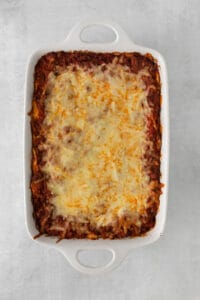 a casserole dish filled with lasagna and cheese.