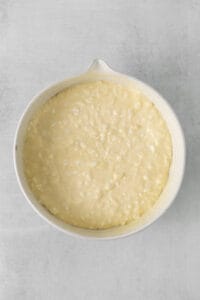 a white dish with a white batter in it.