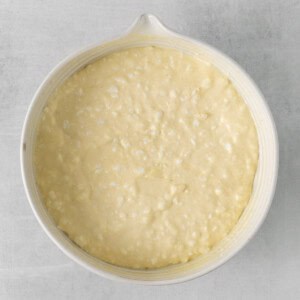 a white dish with a white batter in it.