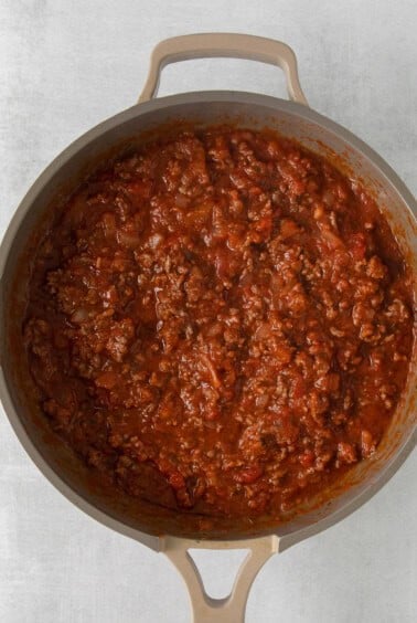 chili in a pan on a white surface.