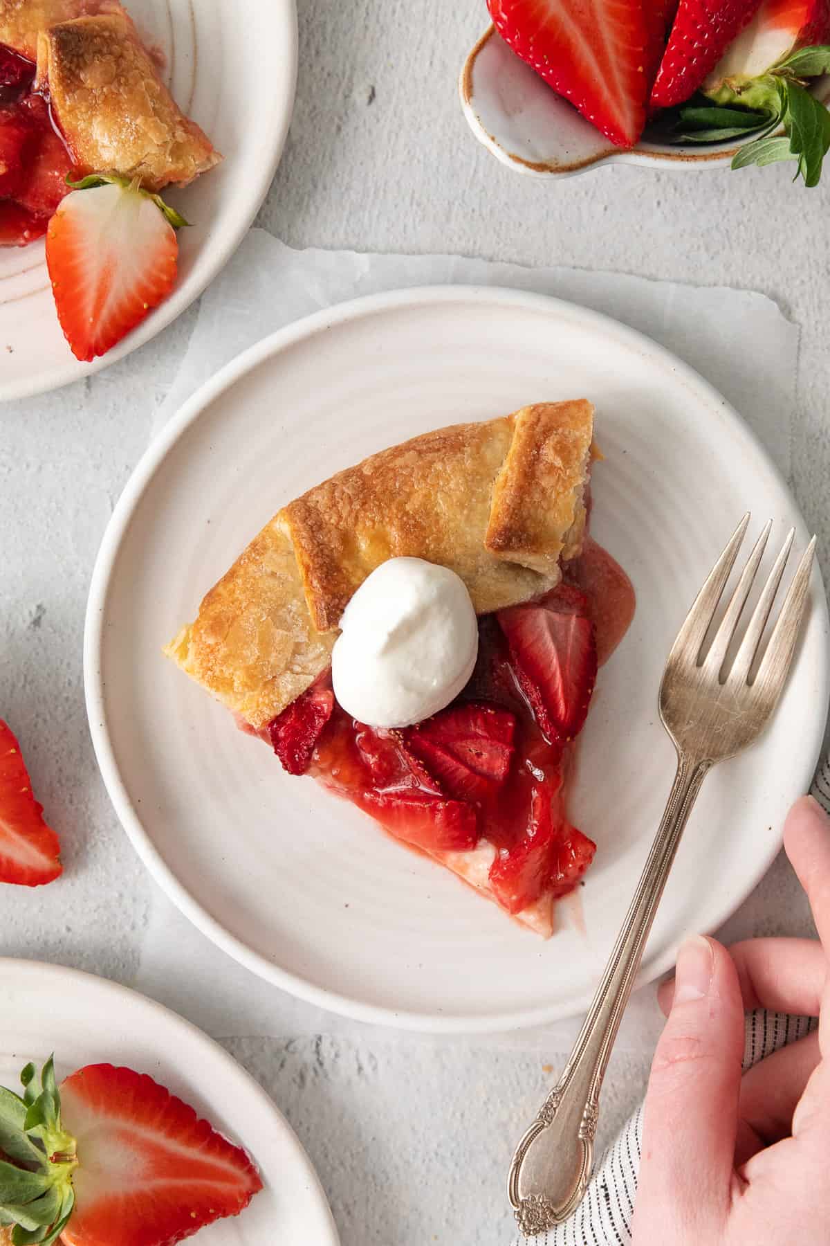 Slice of strawberry cream cheese tart on a plate.