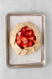 a strawberry galette on a baking sheet.