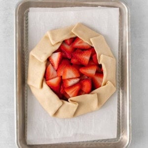 a strawberry galette on a baking sheet.