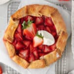 Strawberry cream cheese tart topped with a dollop of whipped cream.