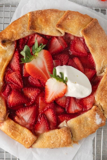 Strawberry cream cheese tart topped with a dollop of whipped cream.
