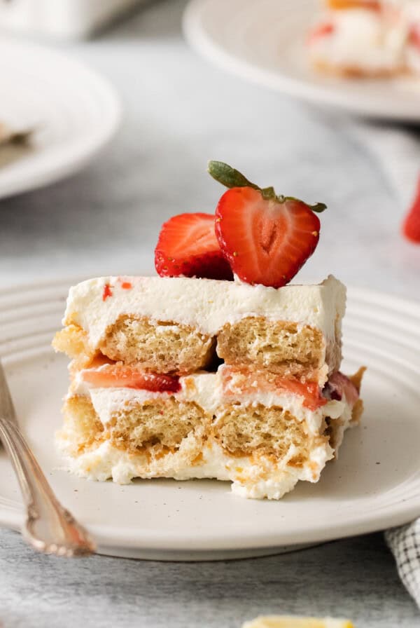 Slice of strawberry tiramisu on a plate.