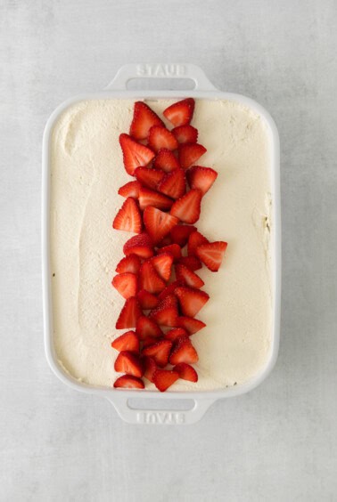 an ice cream cake with strawberries on top.