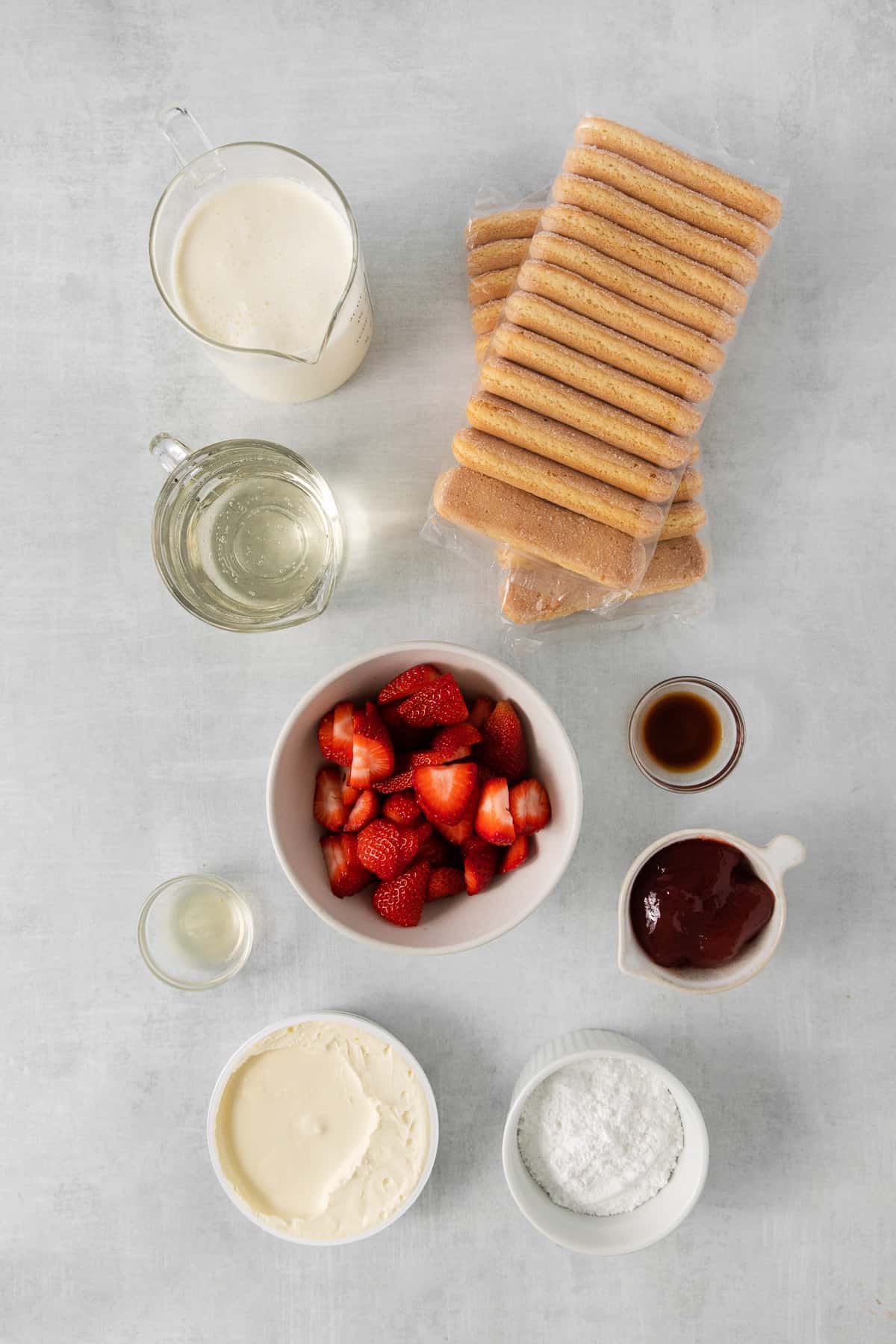 Ingredients for strawberry tiramisu in bowls.