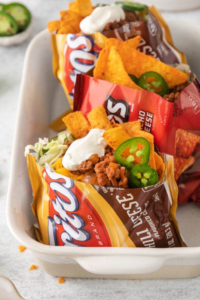 walking tacos assembled in chip bags.