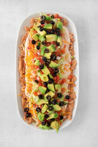 7 layer dip in a serving dish.