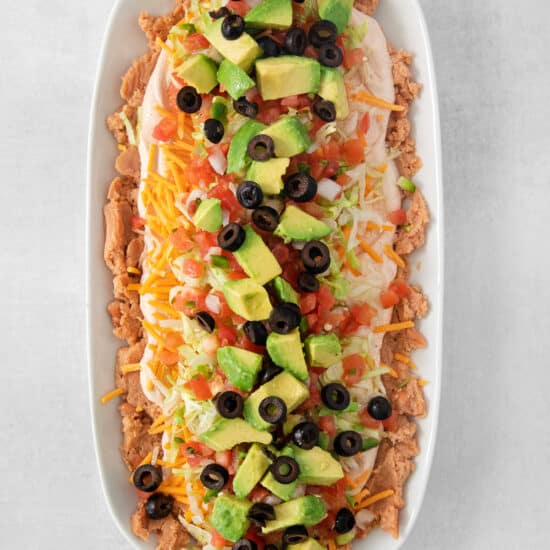 7 layer dip in a serving dish.