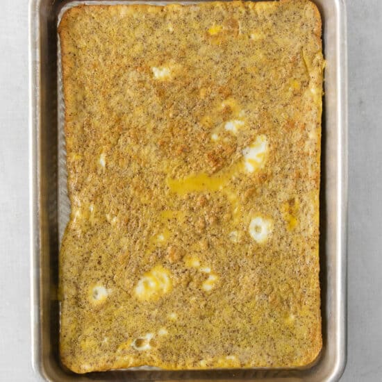 a square of omelette in a metal pan.
