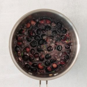 Blueberries cooking down in a stock pot.